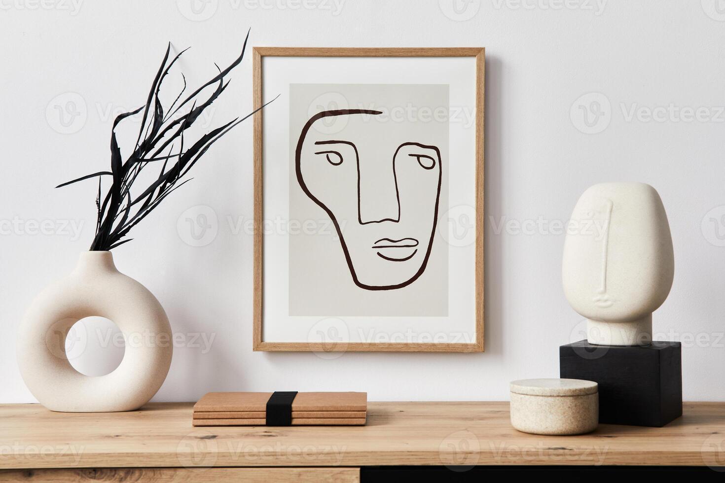 Stylish interior of living room with mock up poster frame, wooden commode, book, leaf in ceramic vase and elegant personal accessories. Minimalist concept of home decor. photo