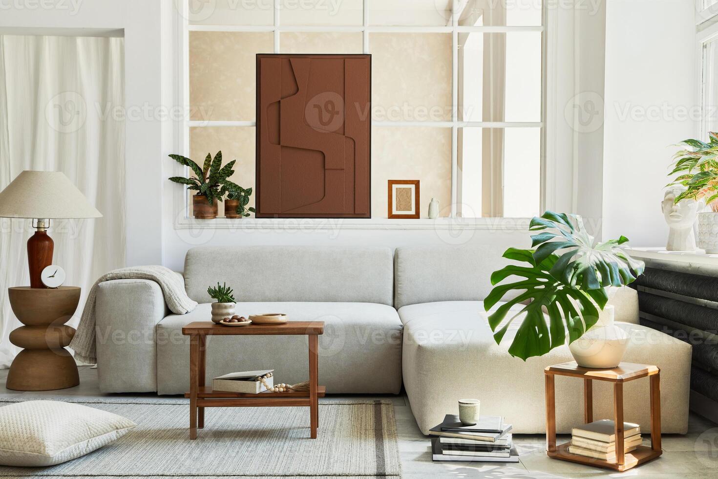 Creative composition of stylish and cozy living room interior with mock up structure painting, grey corner sofa, window, coffee table and personal accessories. Beige neutral colors. photo