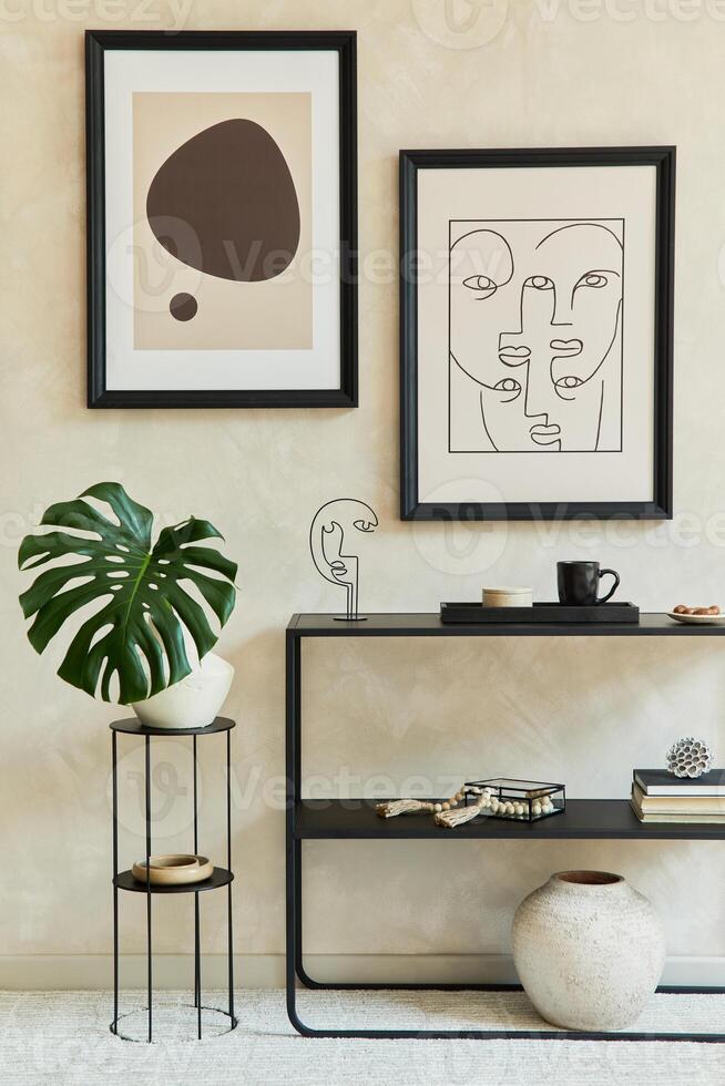 Creative composition of stylish modern living room interior with two mock up poster frames, geometric commode, leaf in vase and personal accessories. Neutral corols. Template. photo