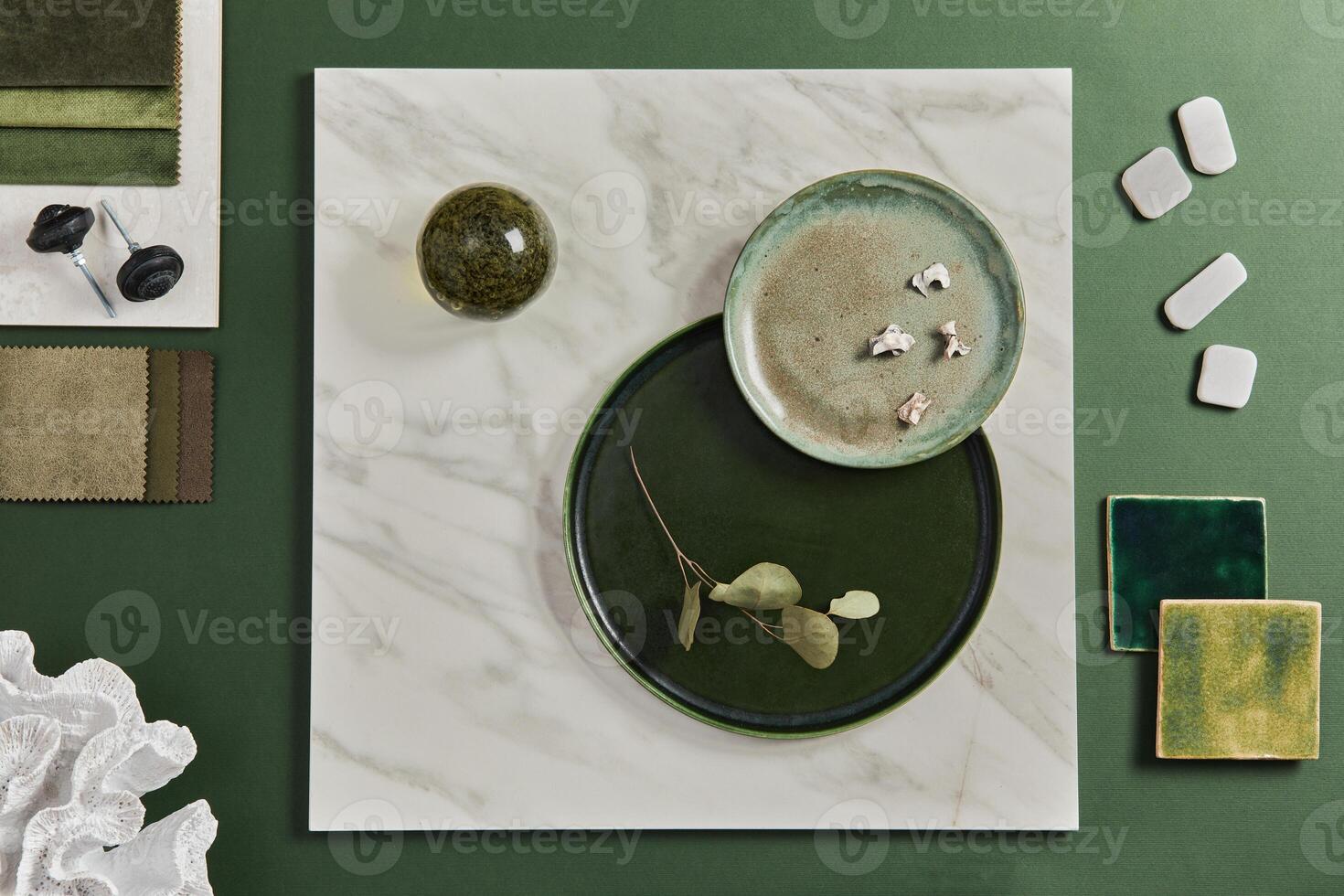 Stylish flat lay composition of creative architect moodboard design with samples of building, textile and natural materials and personal accessories. Top view, green background. photo