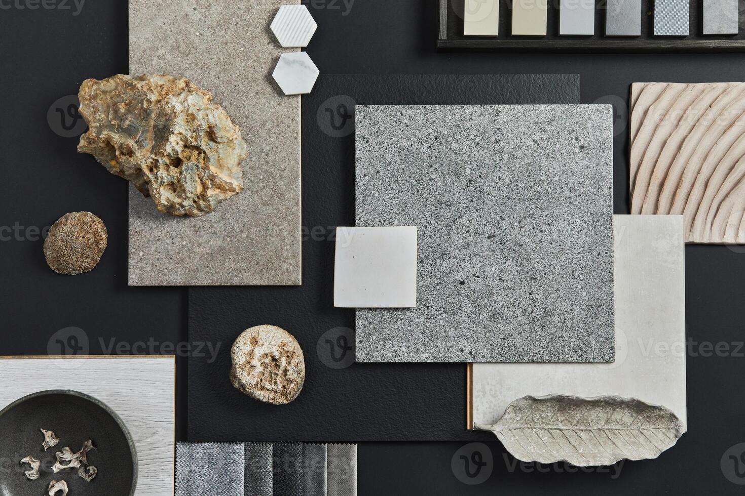 Flat lay composition of creative black architect moodboard with samples of building, textile and natural materials and personal accessories. Top view, black background. photo