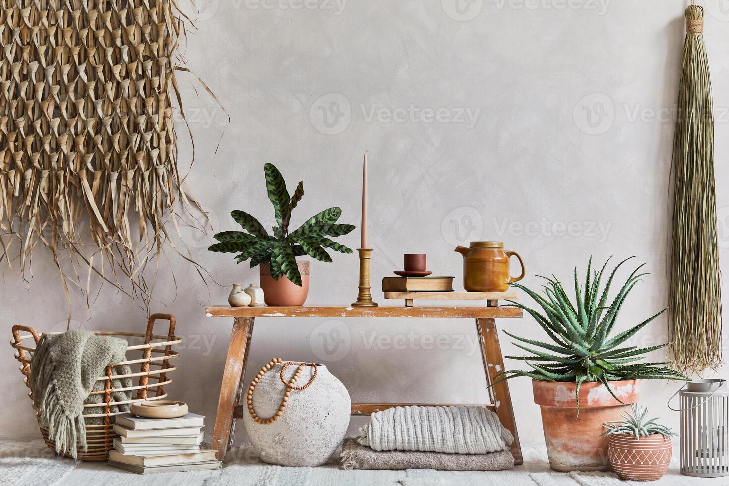 Stylish composition of cozy living room interior with copy space, bench in retro style, clay vase, crockery, straw wall decoration. Rustic inspiration. Summer vibes. Beige wall. Template. photo