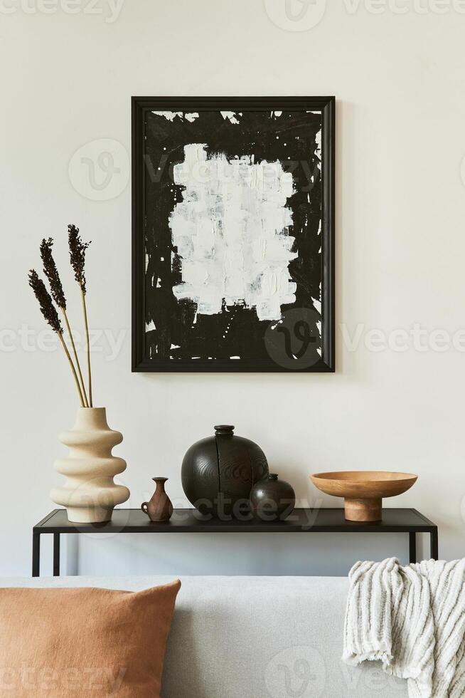 Stylish living room interior design composition with mock up poster frame, corner sofa, coffee table, textile and personal accessories. Scandinavian classic style. photo