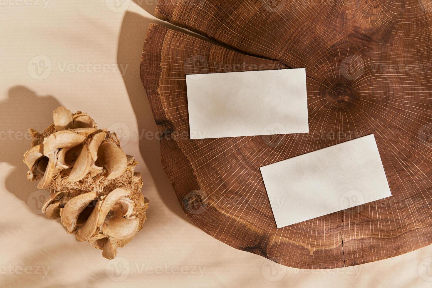 Creative flat lay composition with mock up visit cards, wood, natural materials and accessories. Neutral colors, top view, template. photo