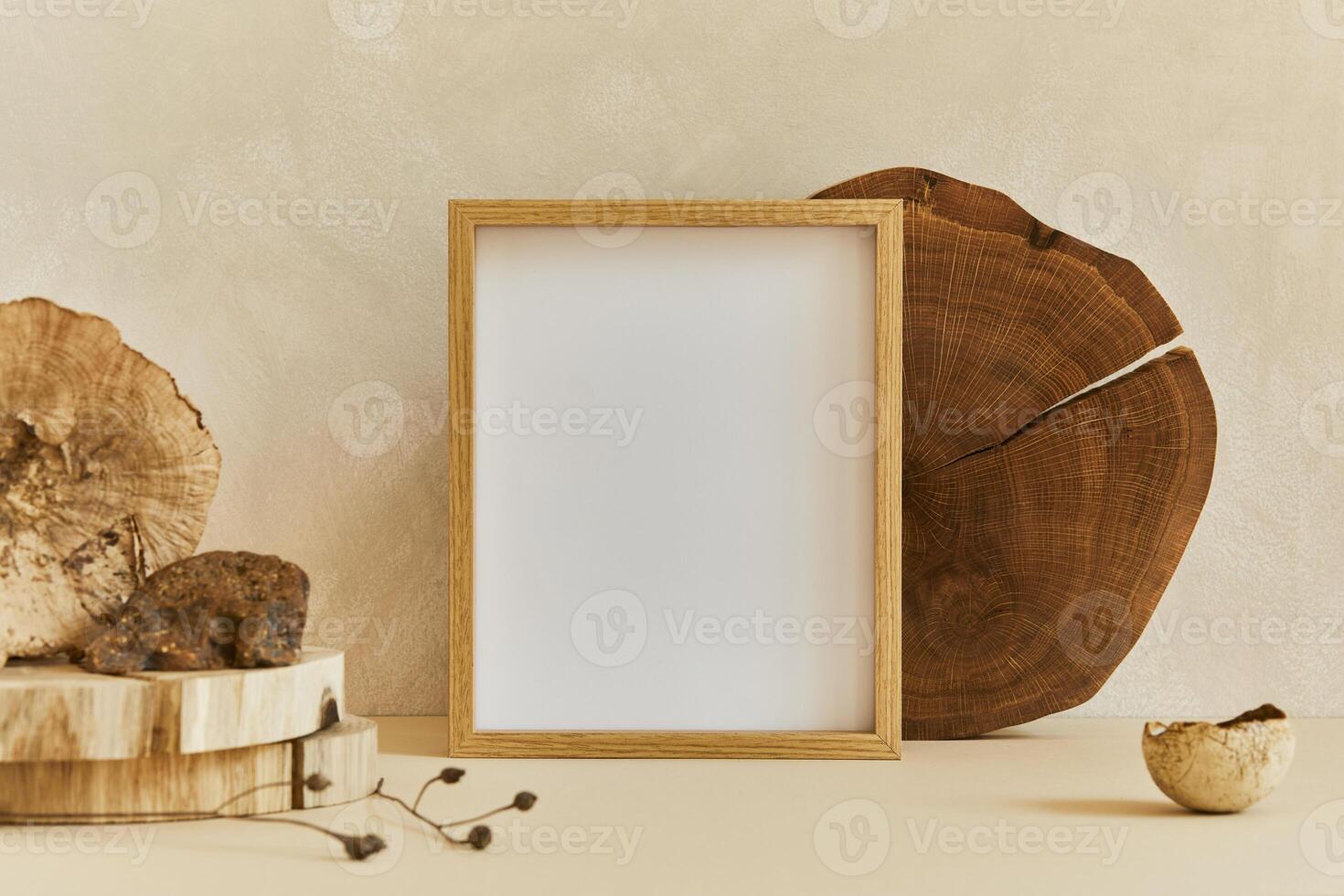 Composition of cozy minimalistic interior design with poster frame, natural materials as wood and marbel, dry plants and personal accessories. Neutral beige colors, template. photo