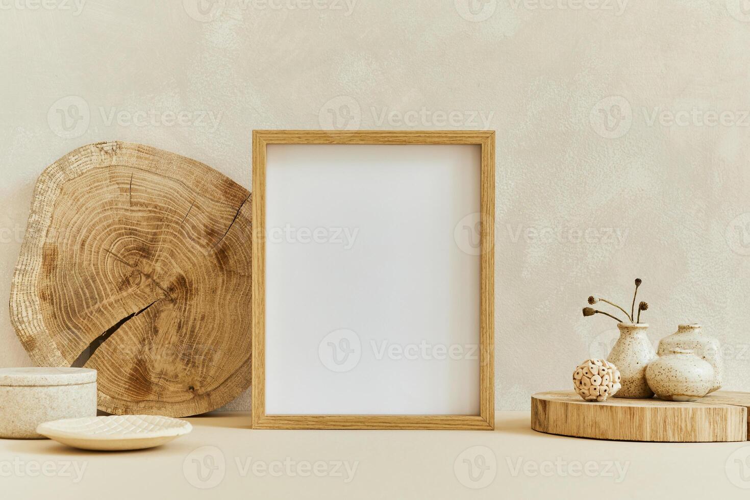 Creative composition of cozy minimalistic interior design with mock up poster frame, natural materials as wood, dry plants and personal accessories. Neutral beige colors photo