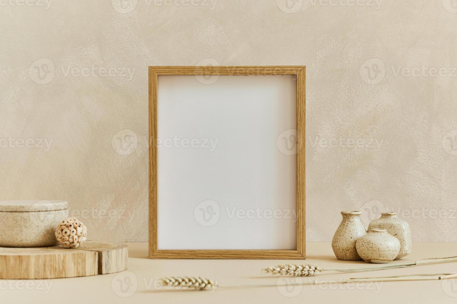 Stylish composition of cozy minimalistic interior design with mock up poster frame, natural materials as wood and marbel, dry plants and personal accessories. Neutral beige colors, photo
