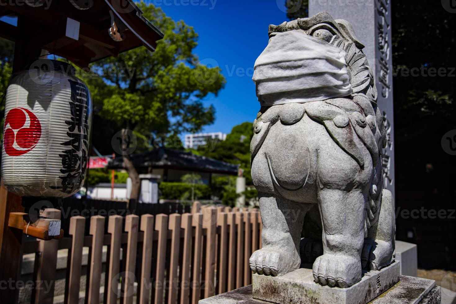 A statue of Guardian dog wearing mask at Meguro fudo temple in Tokyo photo