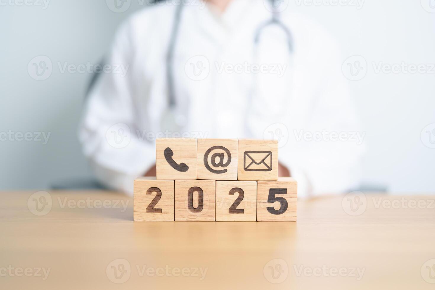 Contact Us concepts. Happy New Year 2025 with Wood block of Email, call Phone and Website Address sign against Doctor background. Healthcare Customer support hotline, health and communication concept photo