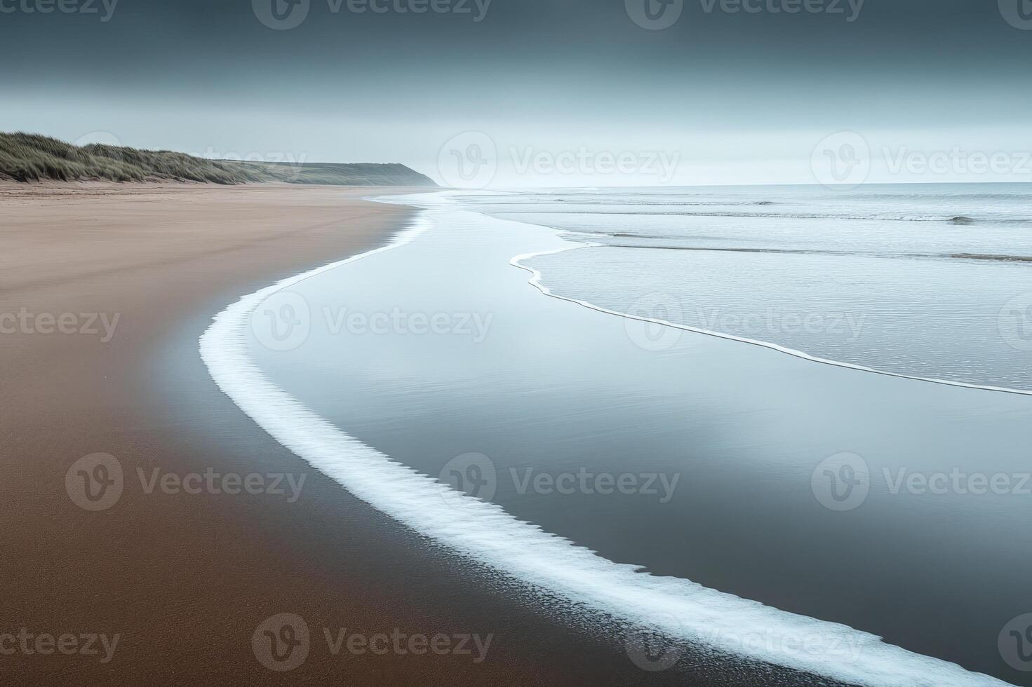 Gentle waves washing ashore on a serene beach at dusk photo