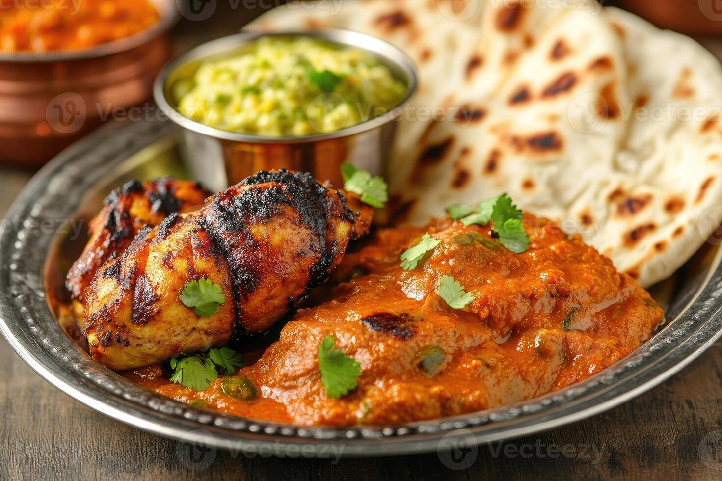 Spicy chicken tikka masala served with basmati rice and naan bread photo