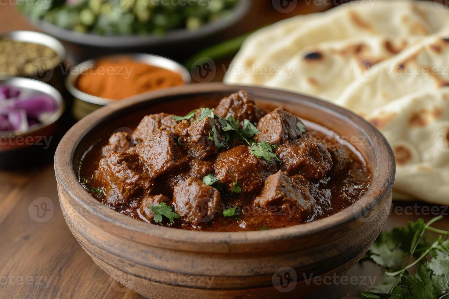 Spicy beef curry served in rustic bowl with cilantro garnish and naan bread photo
