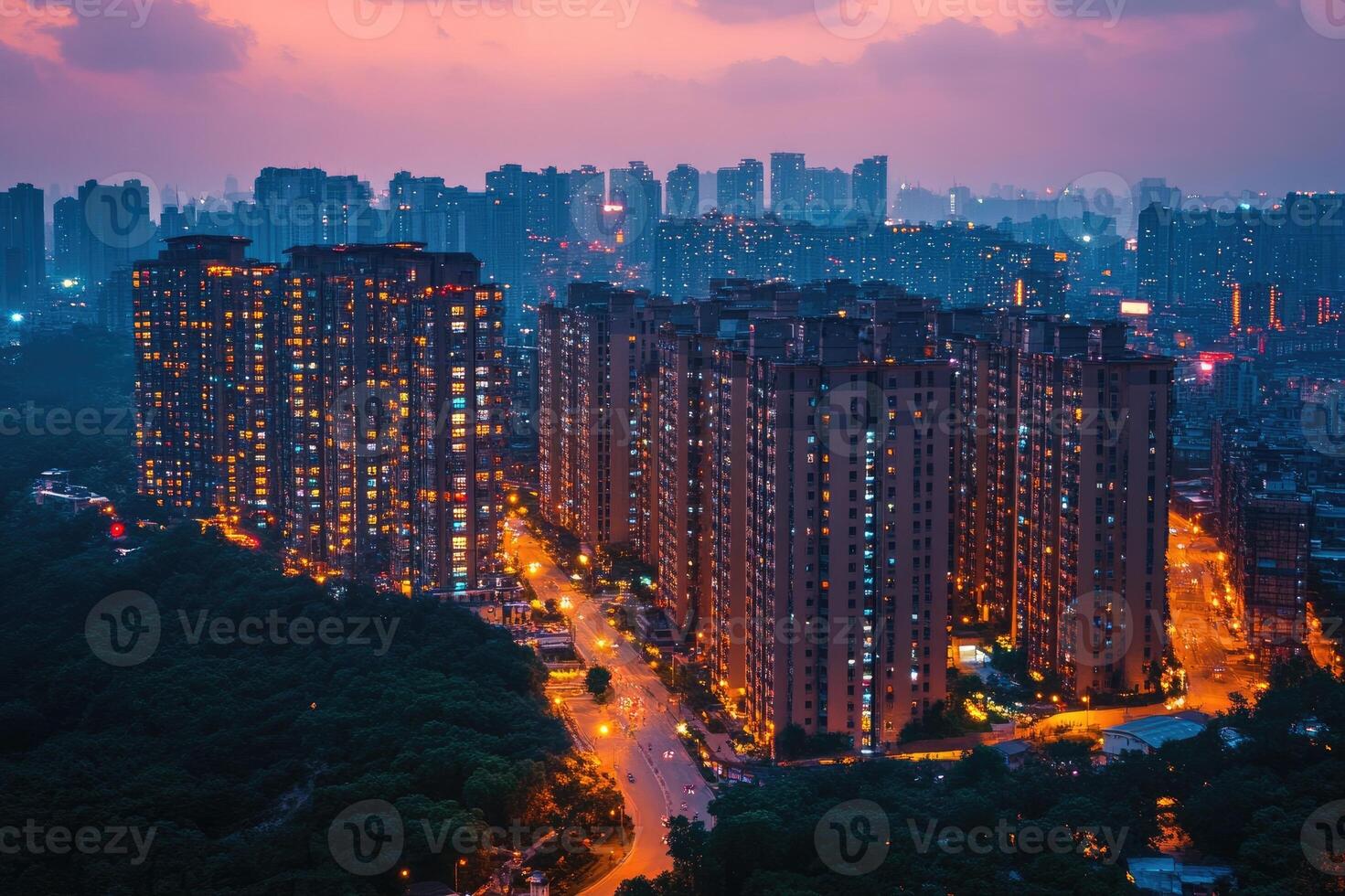 Dense hong kong skyline showing apartment buildings lit up at night photo