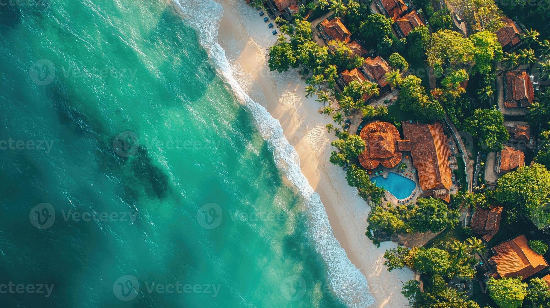 Turquoise ocean water lapping on the shore of a tropical resort island photo