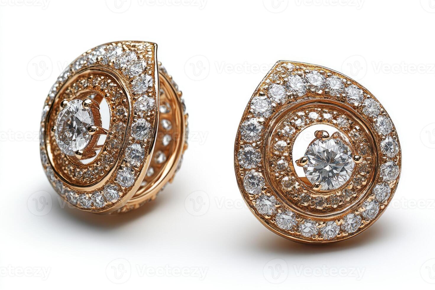 Pair of gold earrings sparkling with numerous diamonds on white background photo