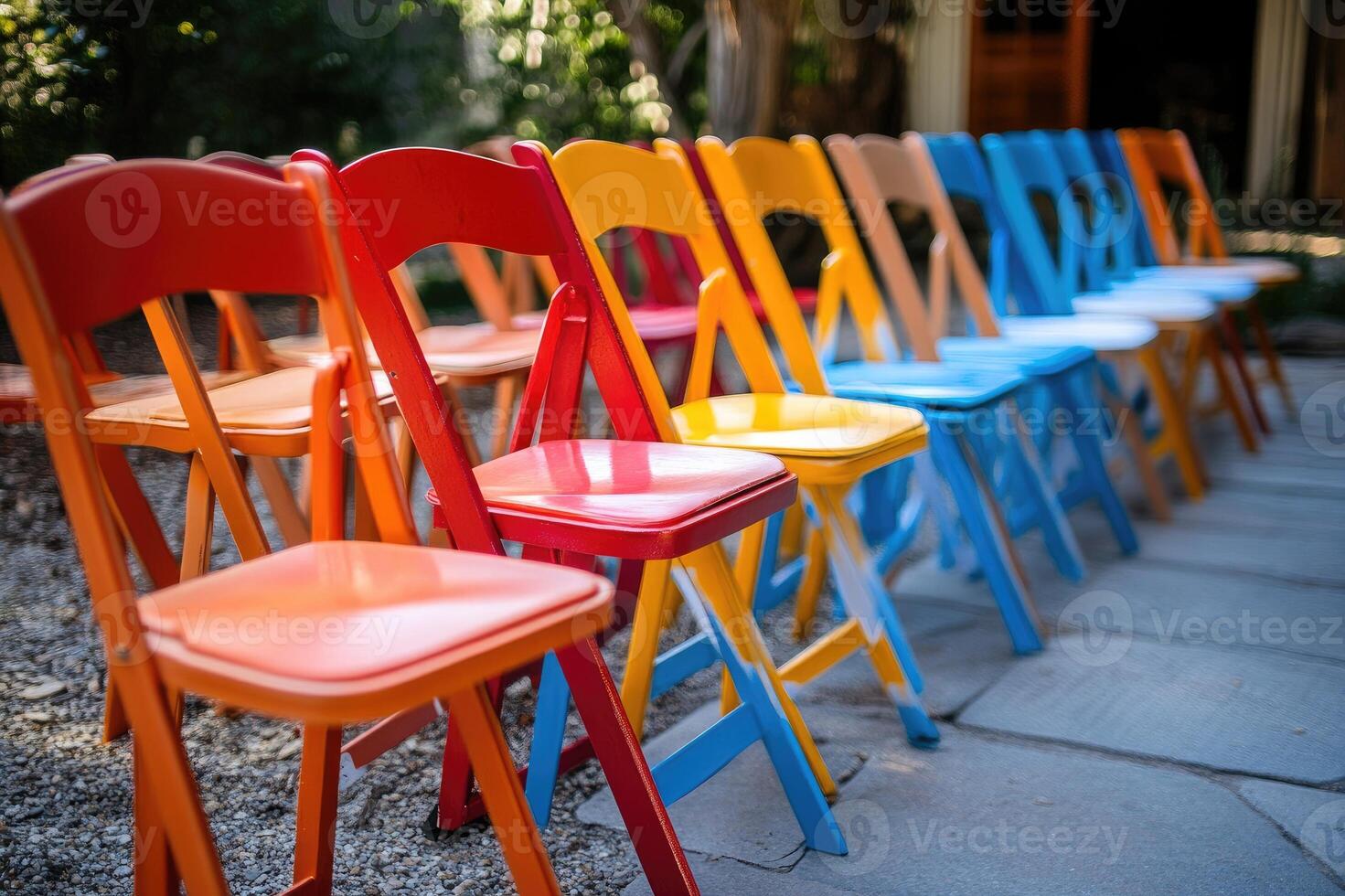 Row of colorful folding chairs in outdoor setting photo