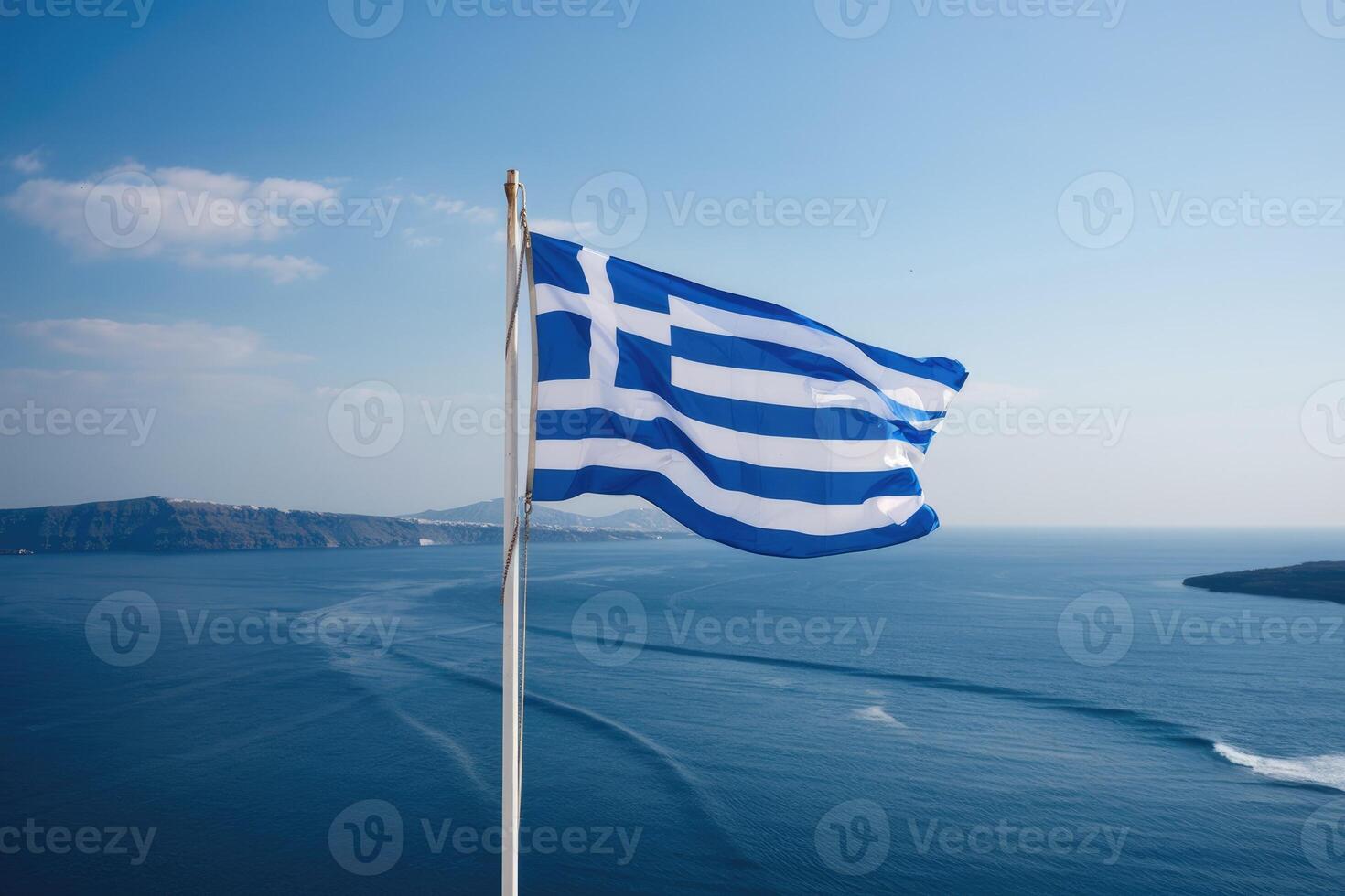 Greek flag waving in santorini, greece, with aegean sea in background photo
