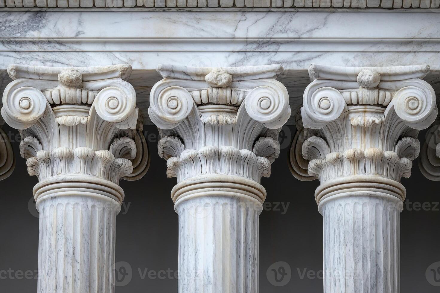 Row of ionic columns supporting marble entablature photo