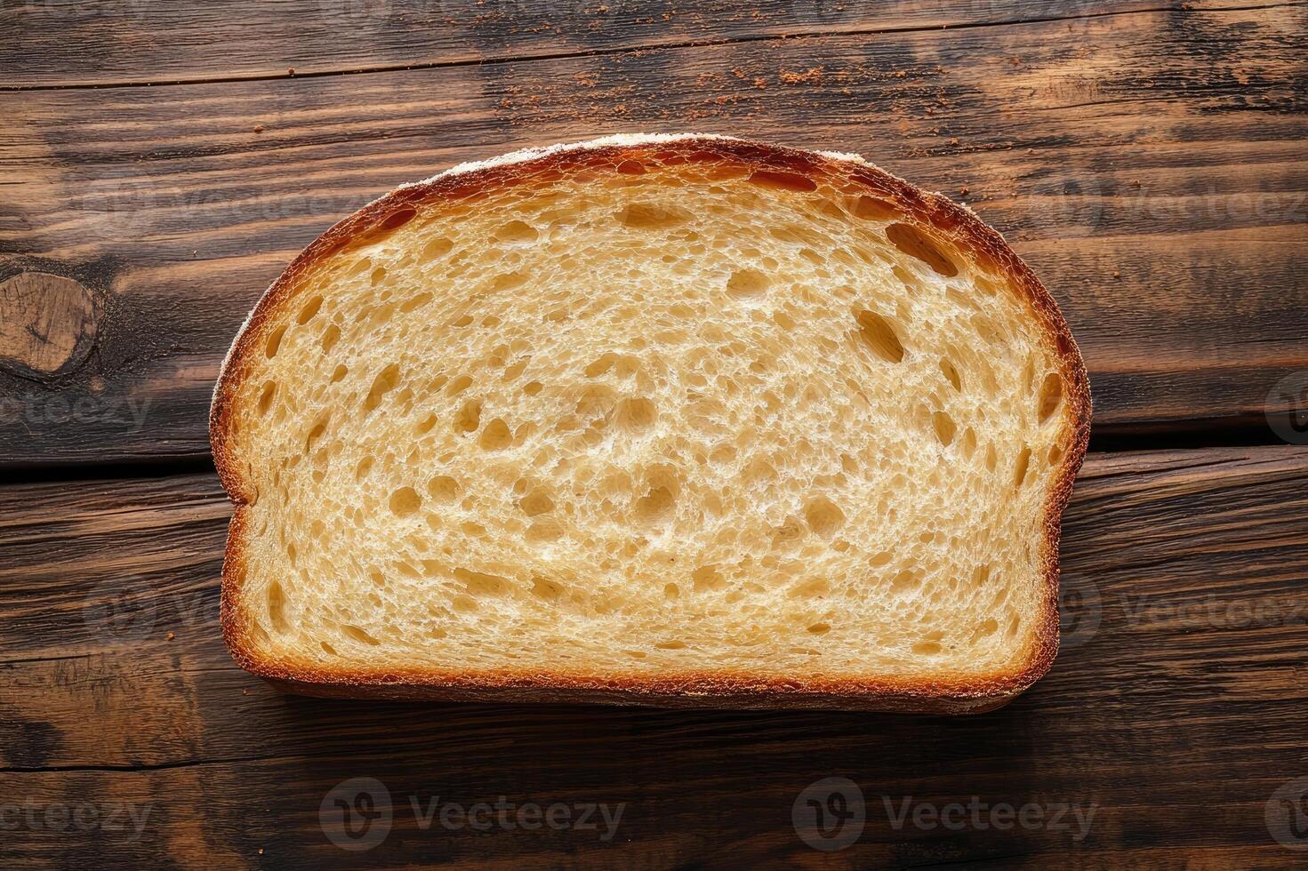 Slice of bread showing its texture on rustic wooden table photo
