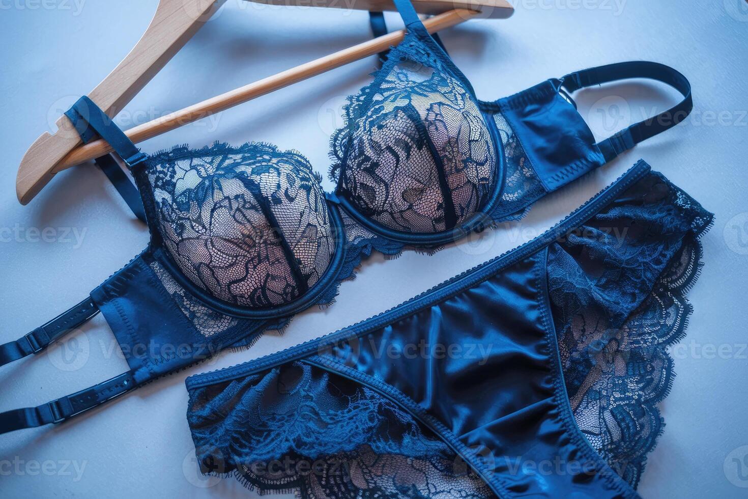 Elegant blue lingerie set hanging on wooden hanger photo