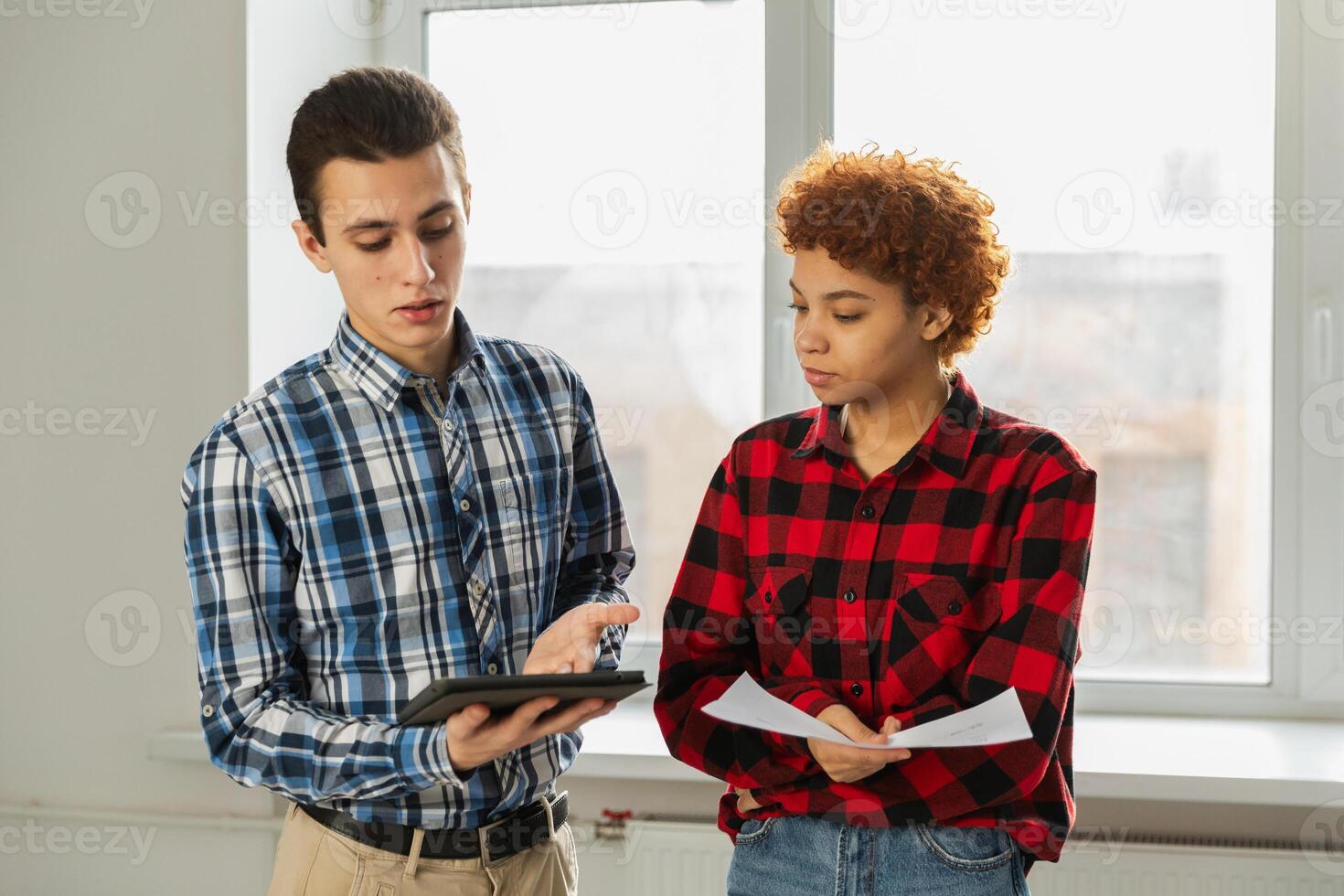 Teamwork brainstorm young professional team concept. Happy multiracial coworkers cooperating working together at office meeting. Diverse colleagues discussing project ideas editing documentation photo