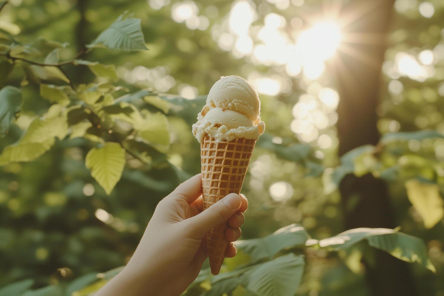 Hand Holding Melting Ice Cream in a Waffle Cone photo