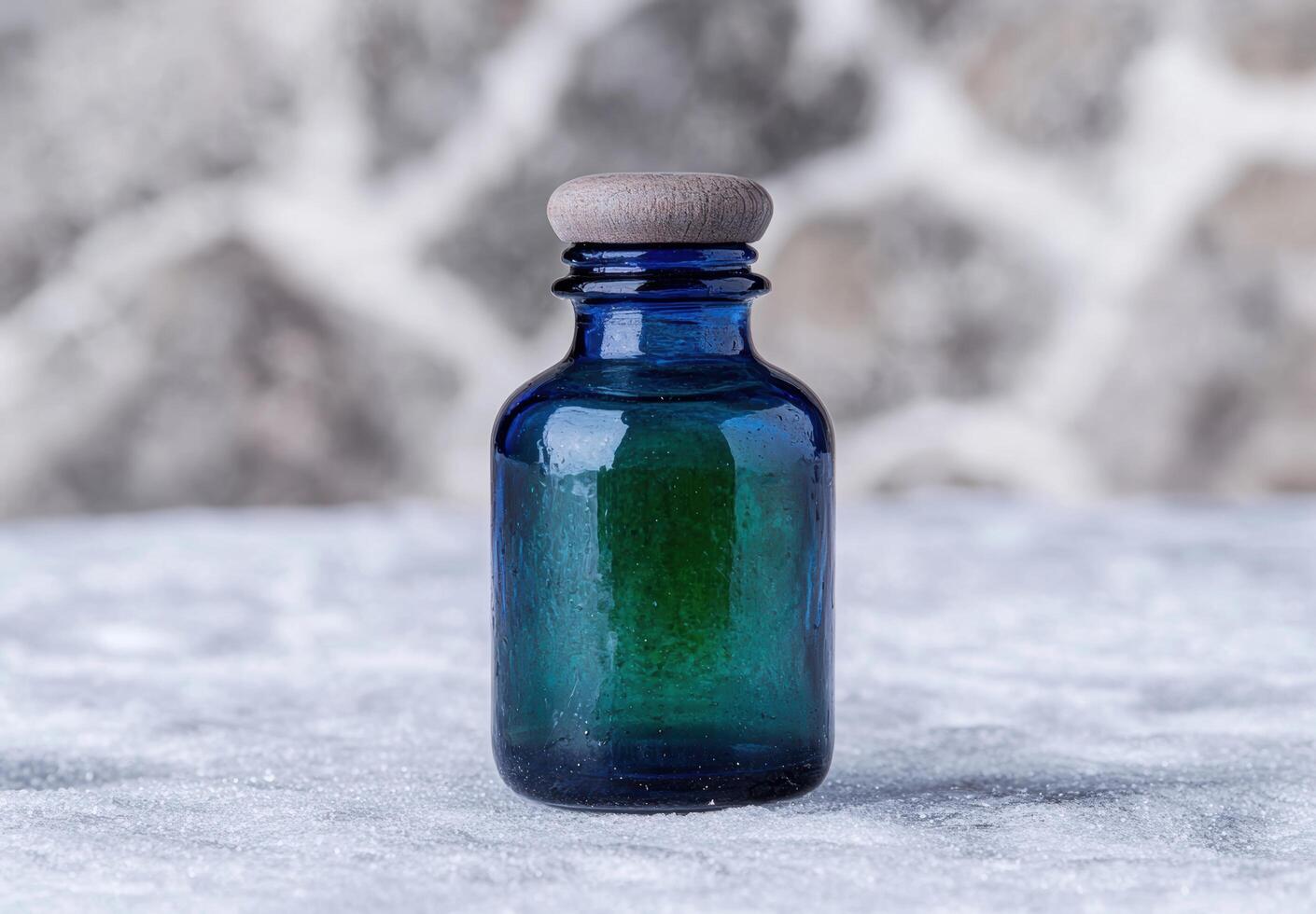 vintage blue glass bottle on snowy background photo