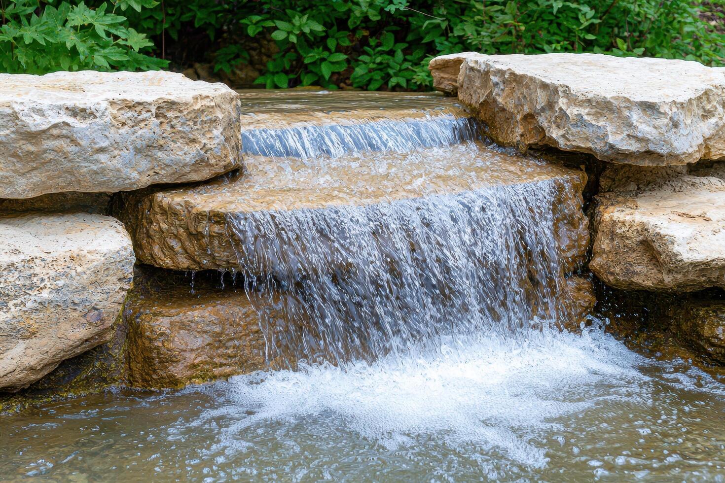 Cascading waterfall in lush green forest photo