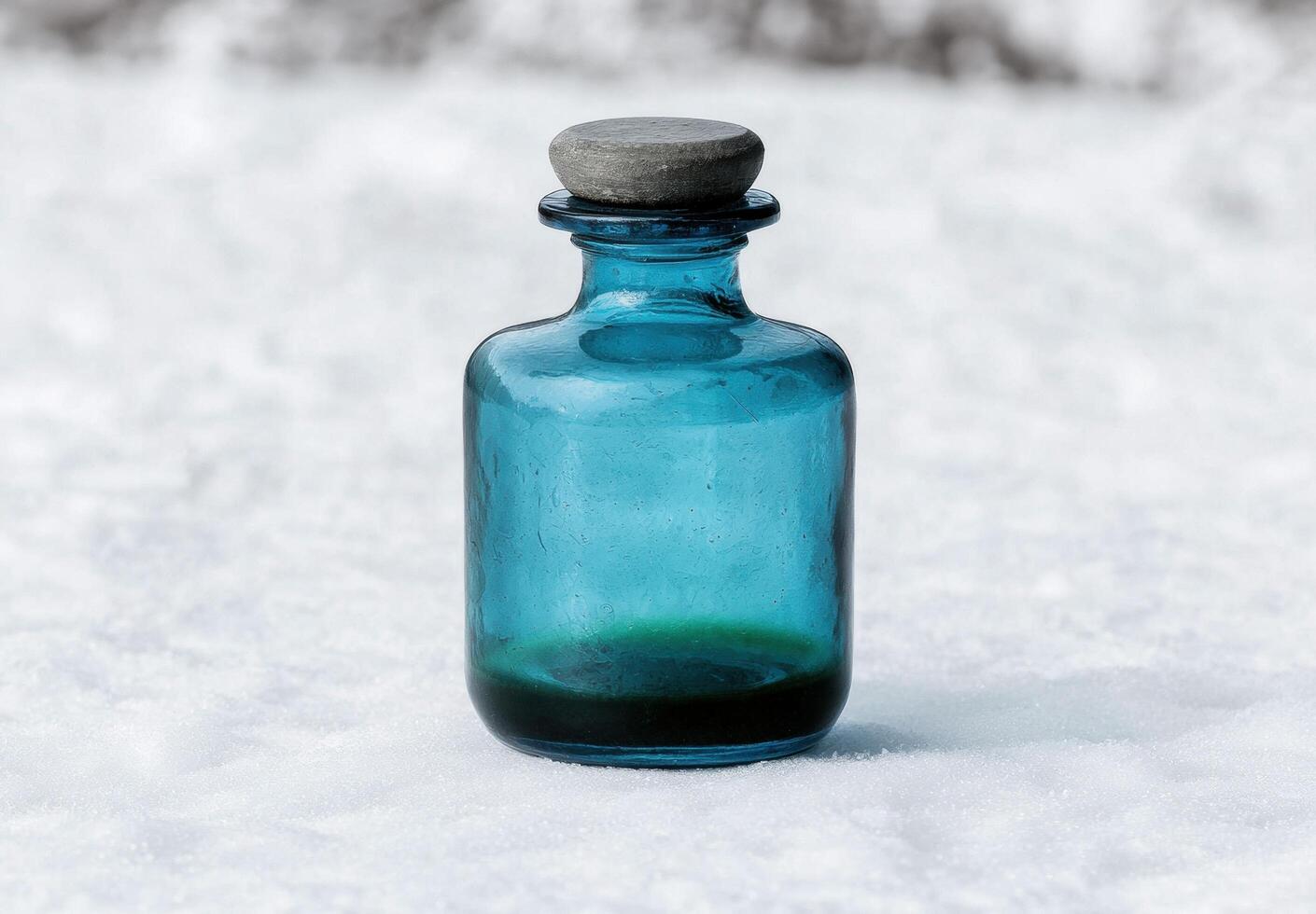 Vintage glass bottle in the snow photo