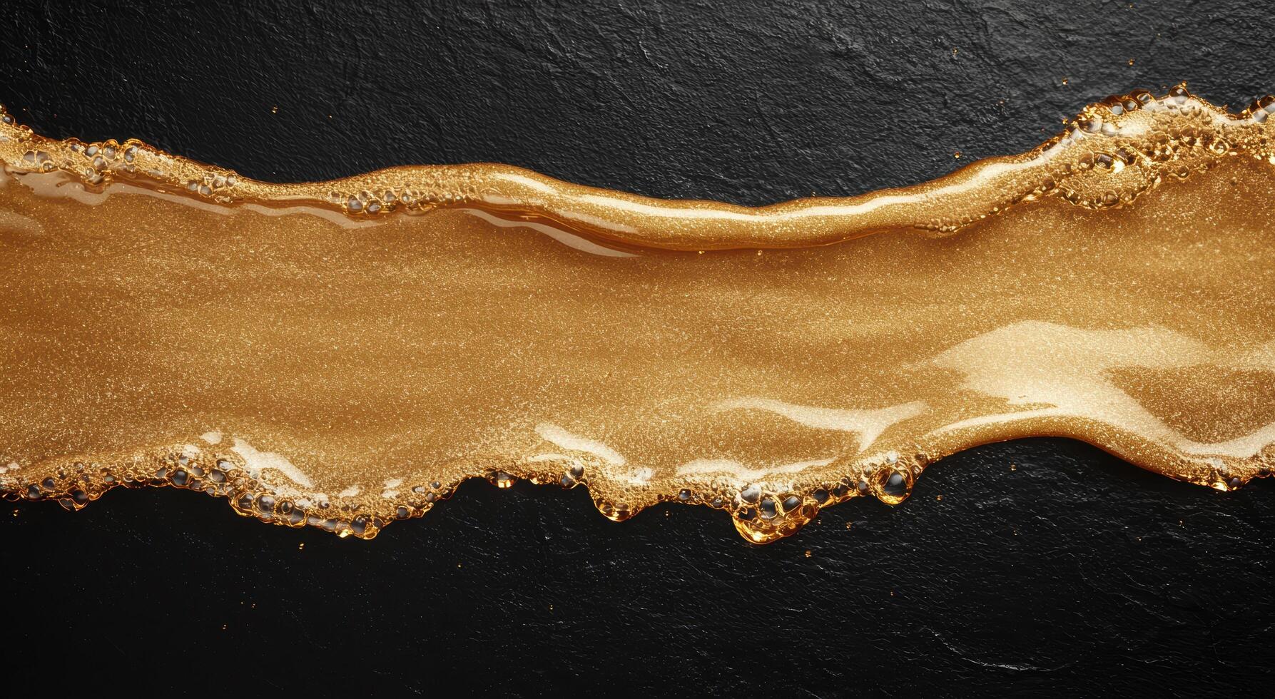 golden liquid flow on dark background photo