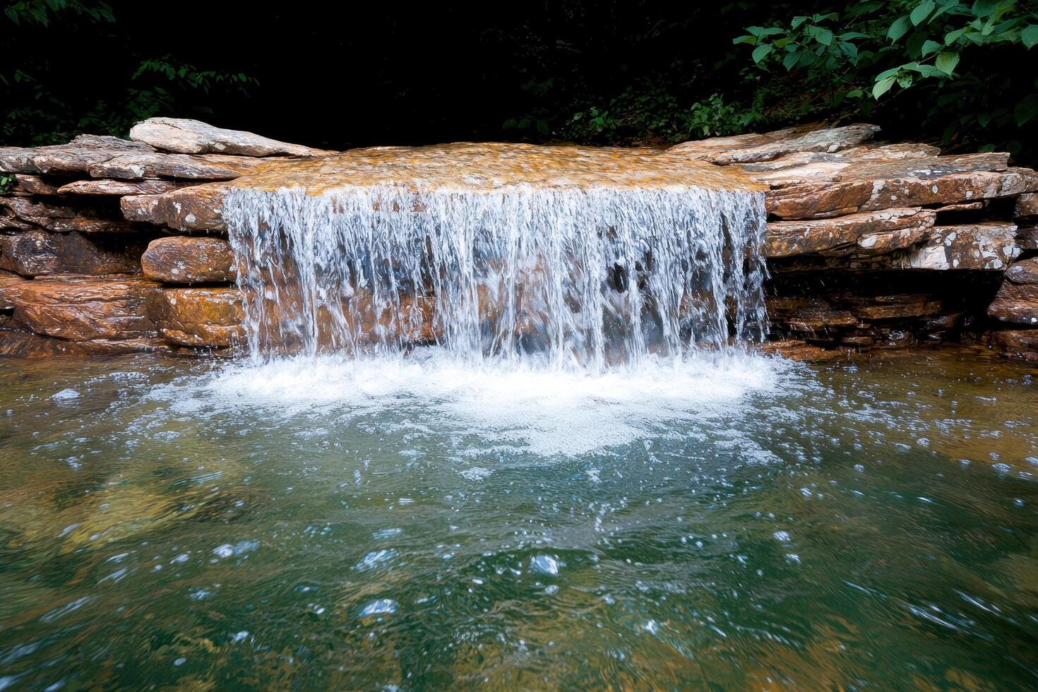 Serene waterfall in lush forest photo