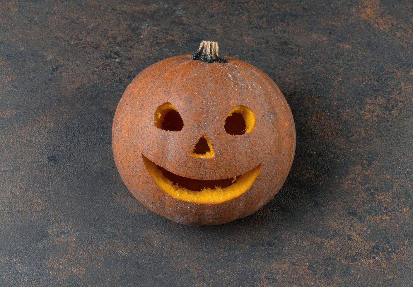 Carved pumpkin with smiling jack o lantern face photo