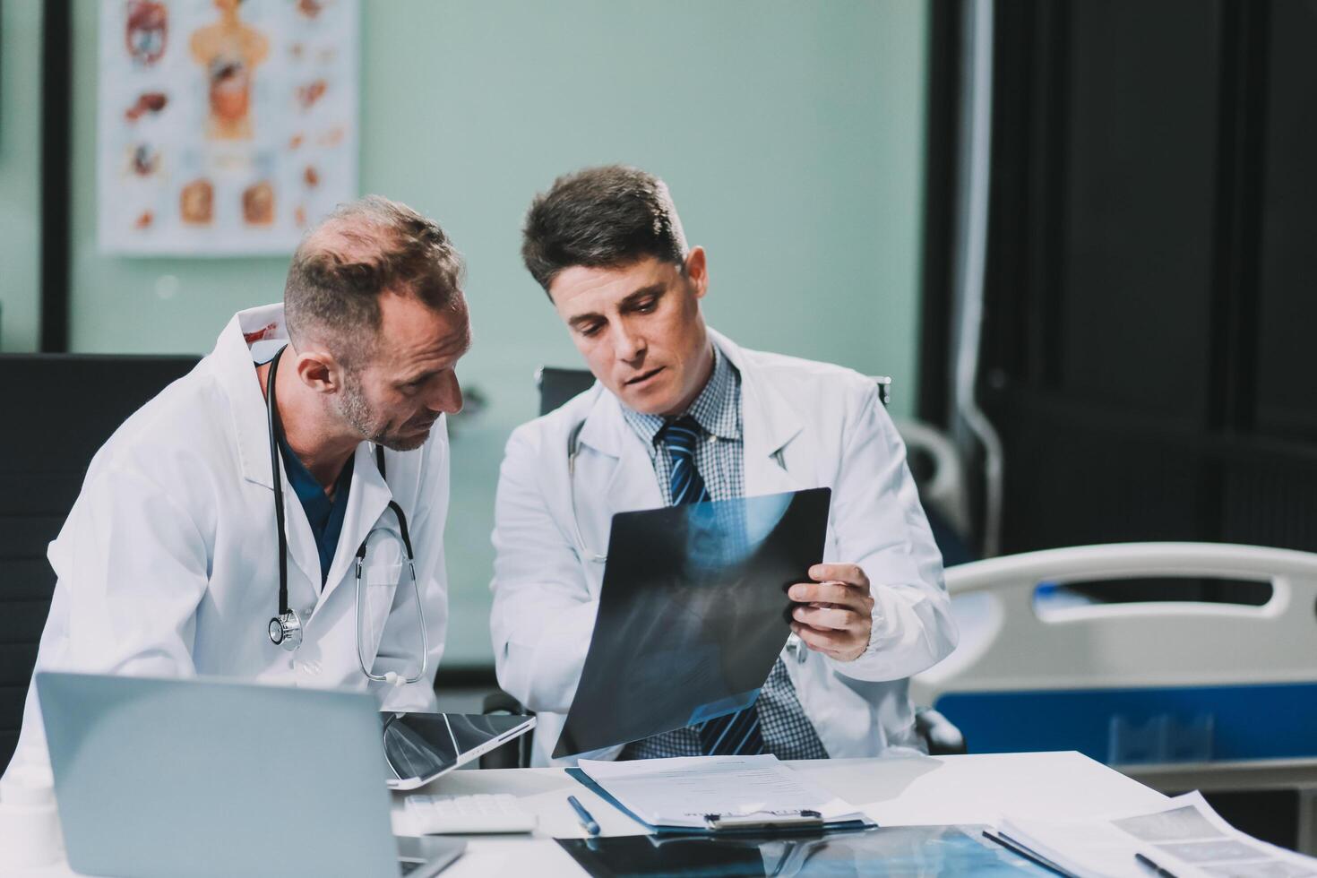 Group of medical practitioners working together and analyzing medical scan in the hospital photo