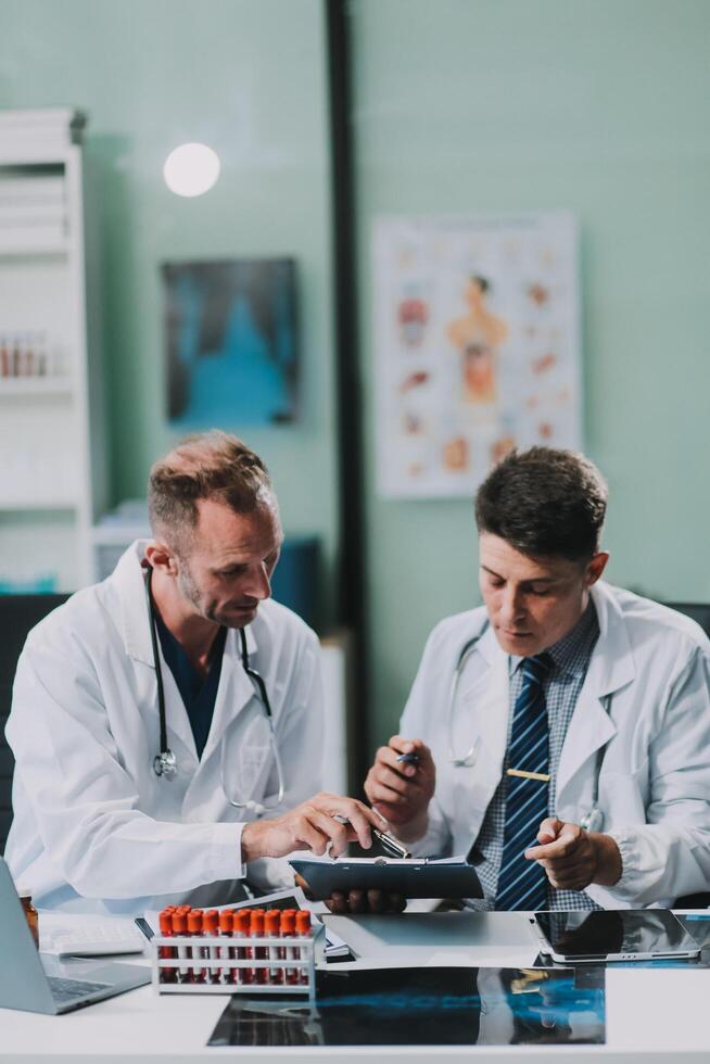 Group of medical practitioners working together and analyzing medical scan in the hospital photo