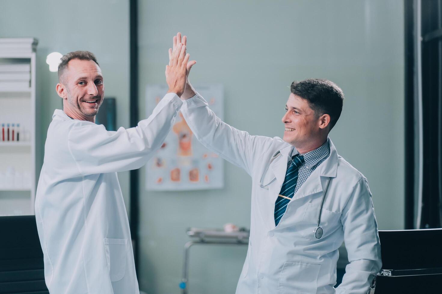 Smiling young male clinician shake hands with happy teammate appreciate for assistance on surgery show support respect on team council. Two doctors partners handshaking making deal reaching agreement photo