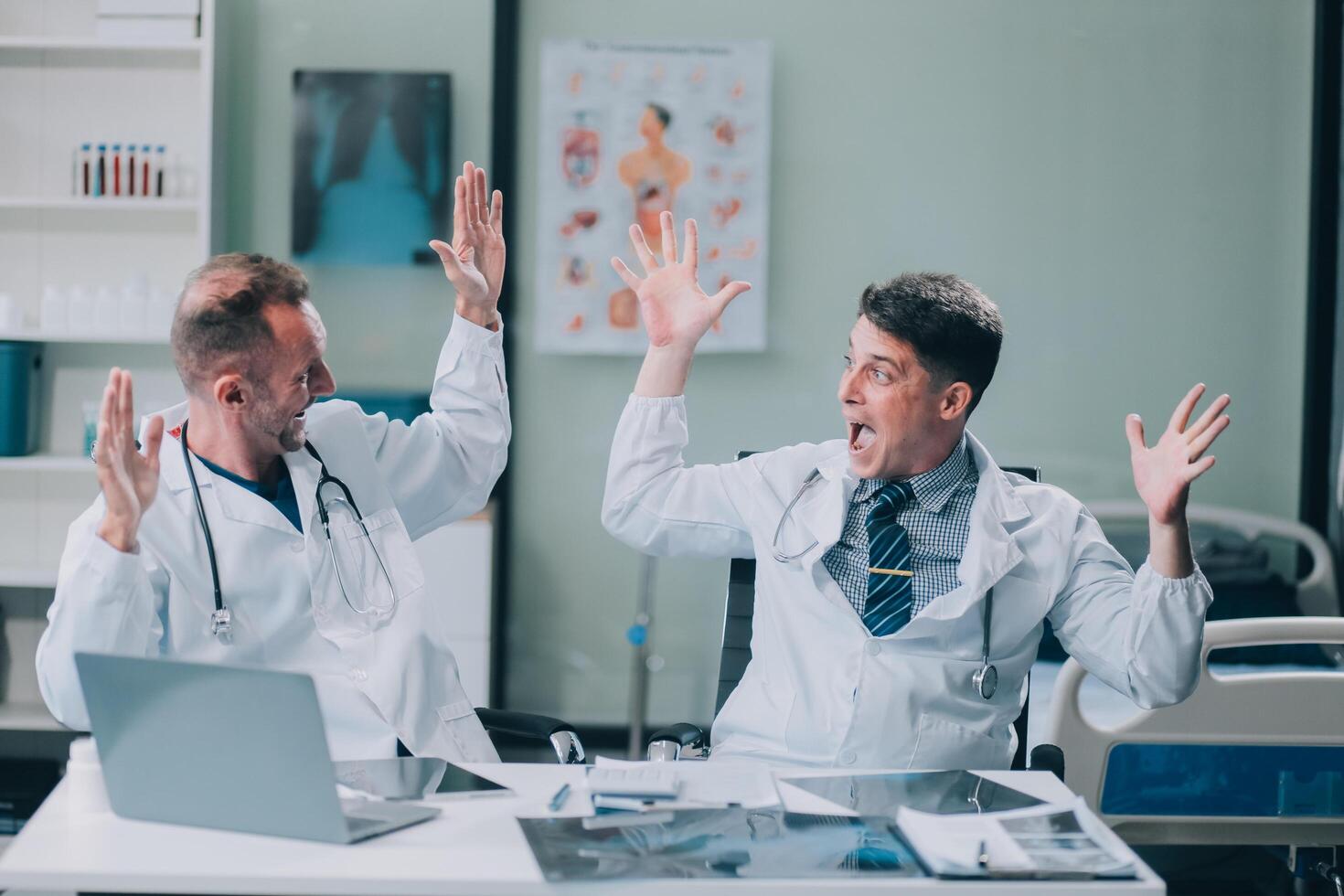 Smiling young male clinician shake hands with happy teammate appreciate for assistance on surgery show support respect on team council. Two doctors partners handshaking making deal reaching agreement photo