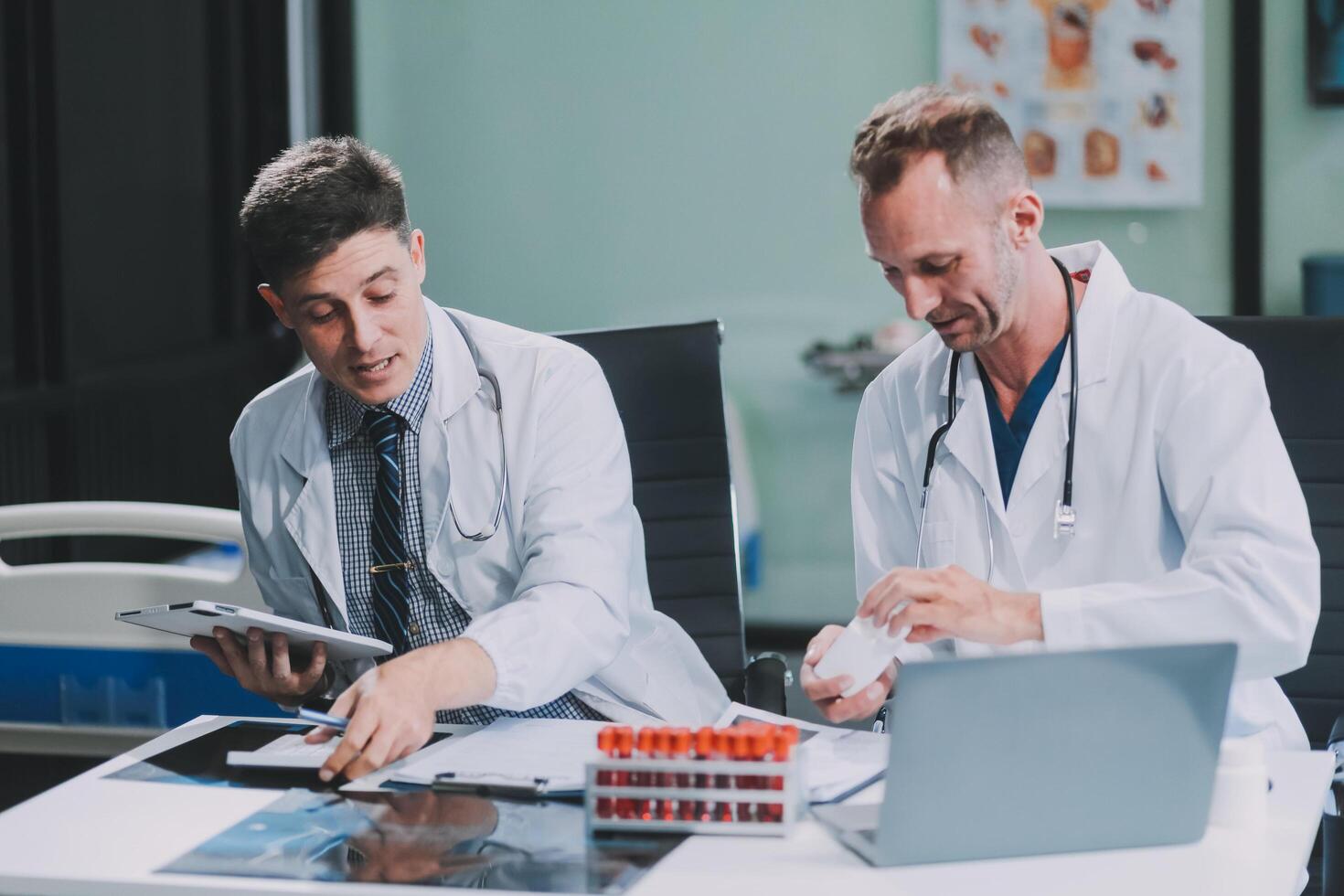 Group of medical practitioners working together and analyzing medical scan in the hospital photo
