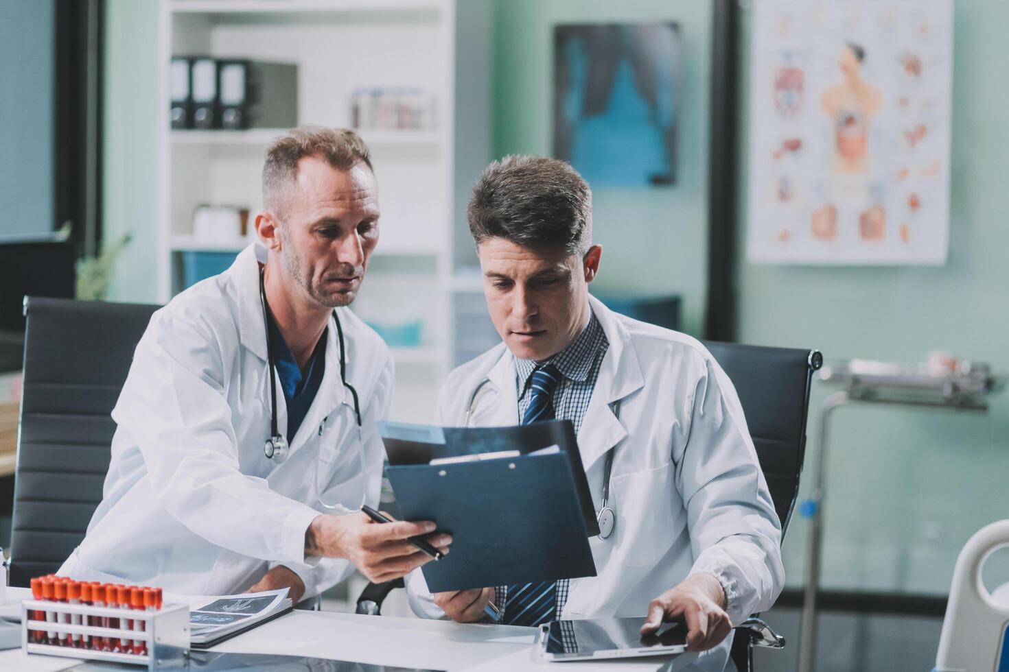 Group of medical practitioners working together and analyzing medical scan in the hospital photo
