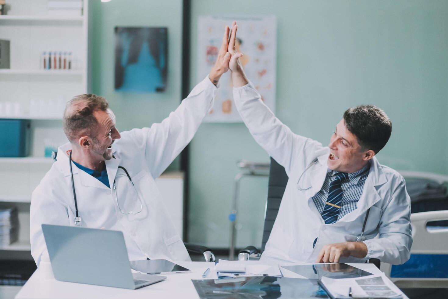 Smiling young male clinician shake hands with happy teammate appreciate for assistance on surgery show support respect on team council. Two doctors partners handshaking making deal reaching agreement photo