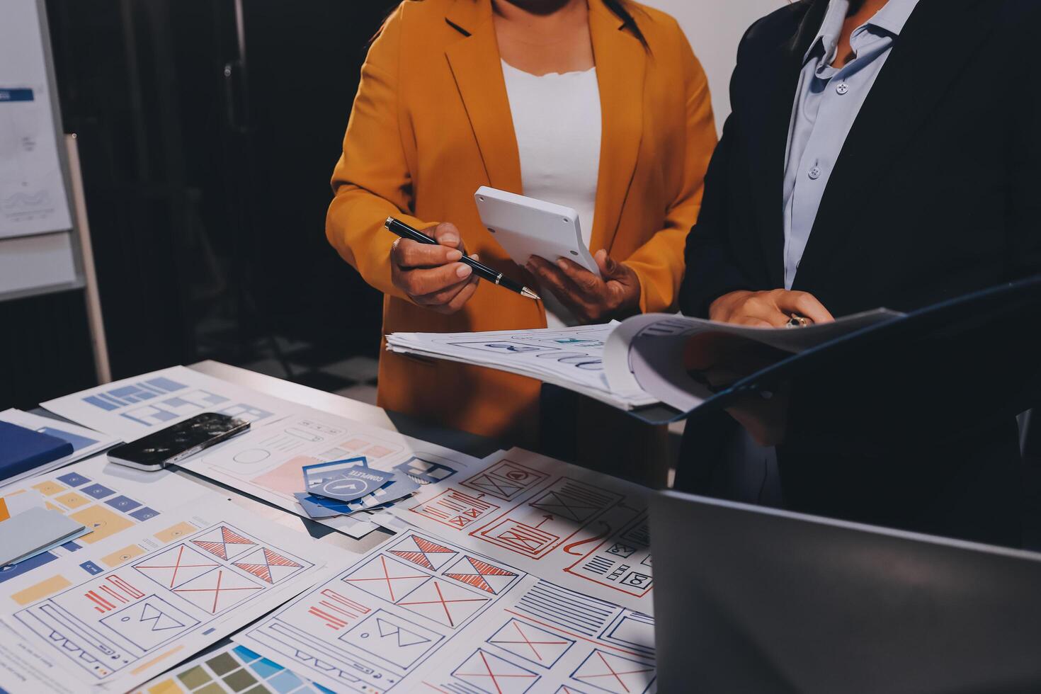 The designer team is designing the uxui system to make the uxui system work well on new phones and support system updates. Website development concept UI UX front end designer photo