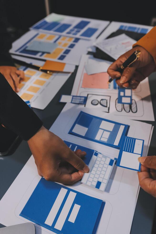 The designer team is designing the uxui system to make the uxui system work well on new phones and support system updates. Website development concept UI UX front end designer photo