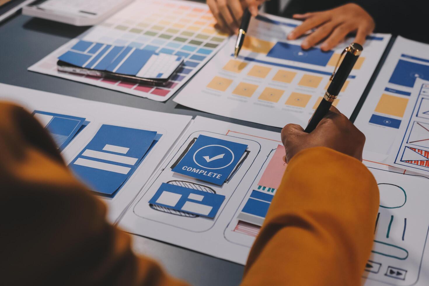 The designer team is designing the uxui system to make the uxui system work well on new phones and support system updates. Website development concept UI UX front end designer photo