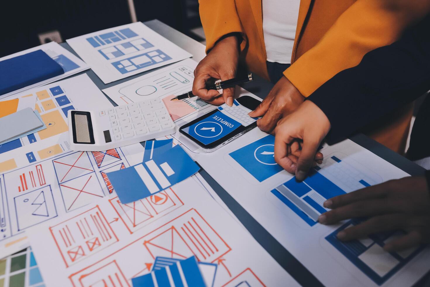 The designer team is designing the uxui system to make the uxui system work well on new phones and support system updates. Website development concept UI UX front end designer photo