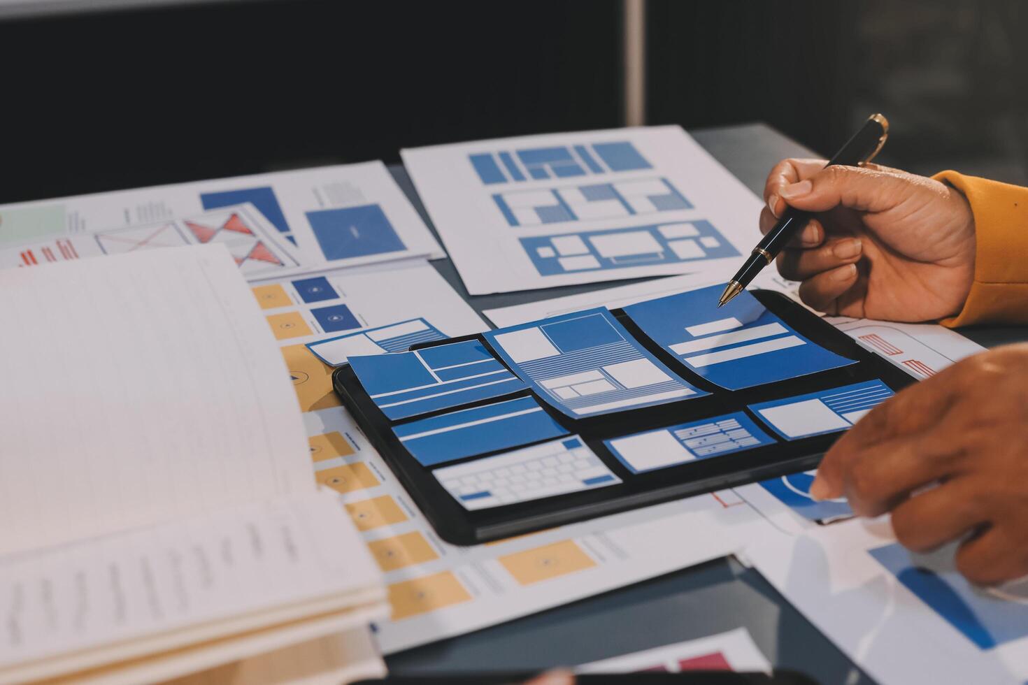 The designer team is designing the uxui system to make the uxui system work well on new phones and support system updates. Website development concept UI UX front end designer photo