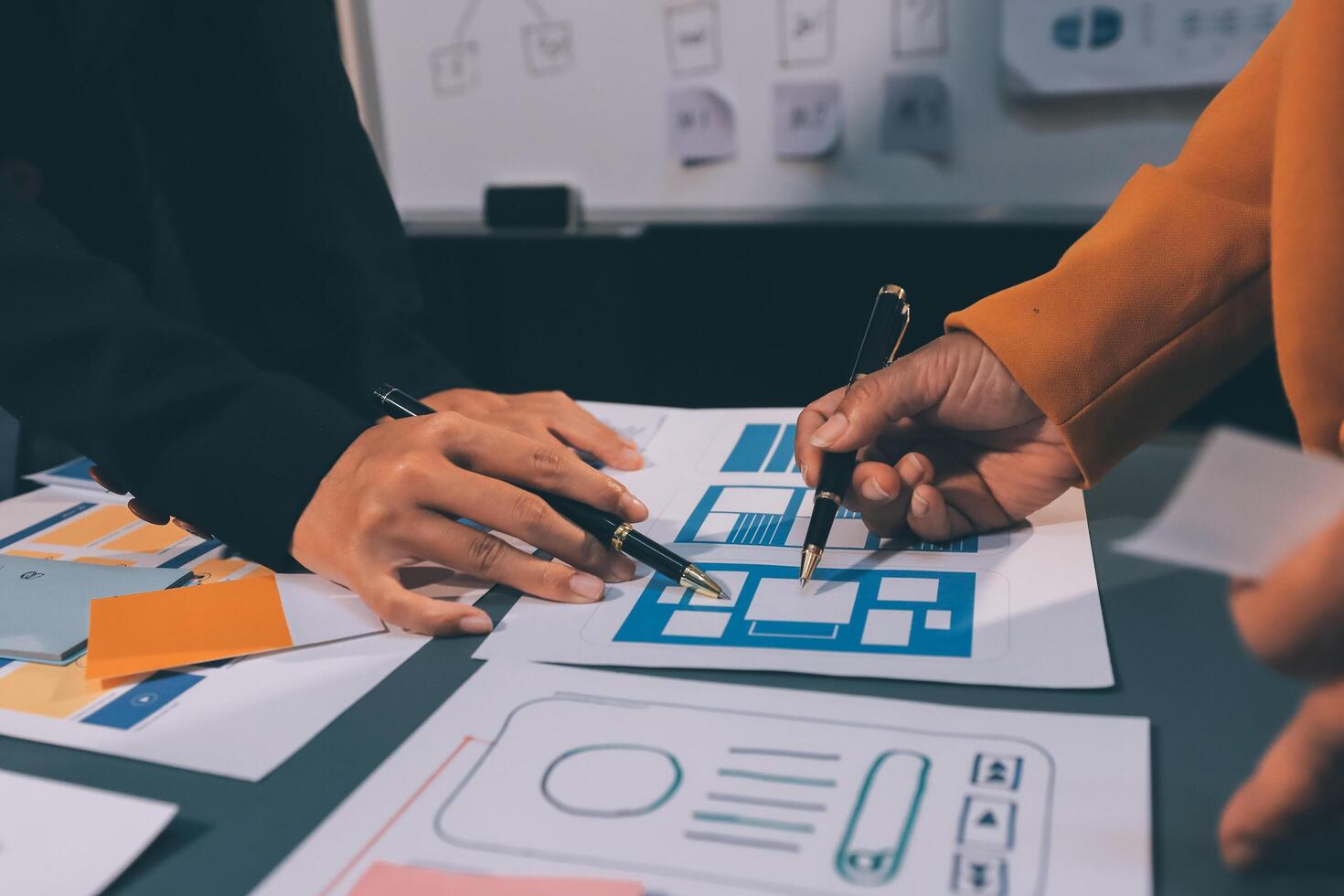 The designer team is designing the uxui system to make the uxui system work well on new phones and support system updates. Website development concept UI UX front end designer photo