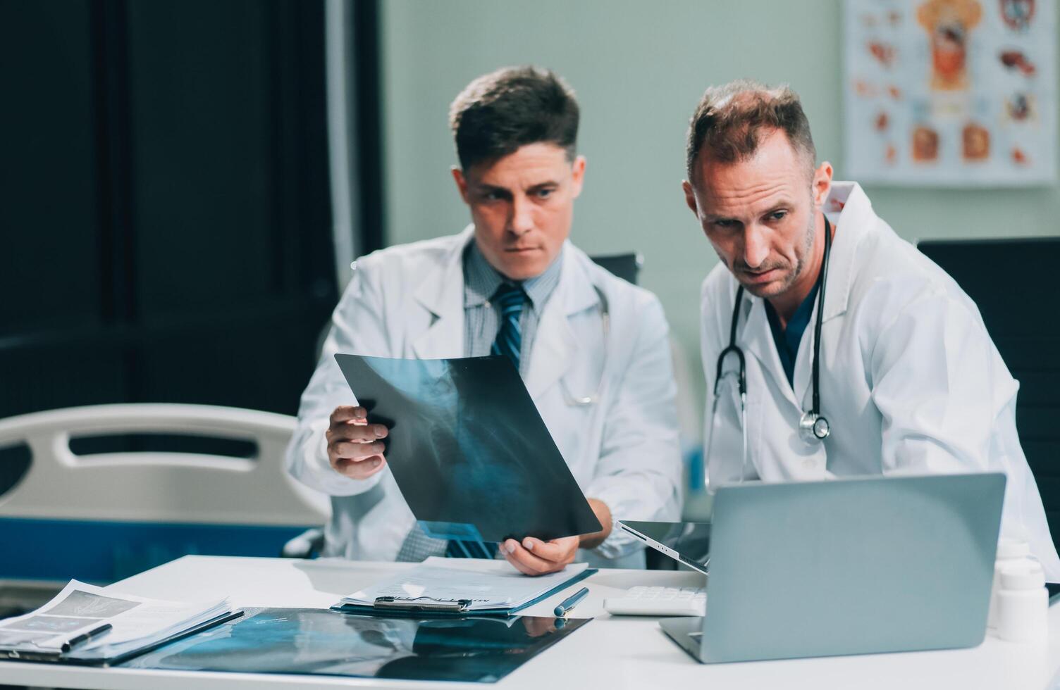 Group of medical practitioners working together and analyzing medical scan in the hospital photo