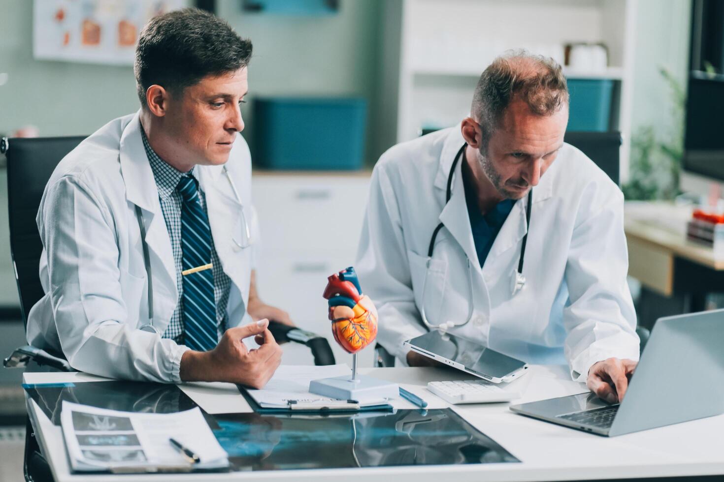 Group of medical practitioners working together and analyzing medical scan in the hospital photo