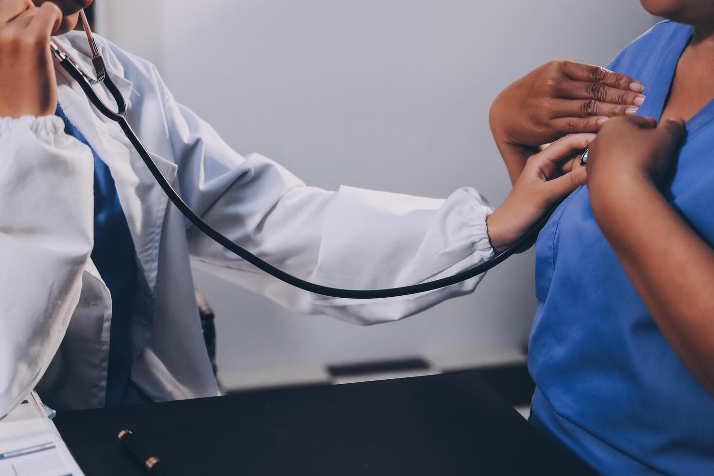 Female doctor use stethoscope to examine eldely paient heartbeat photo