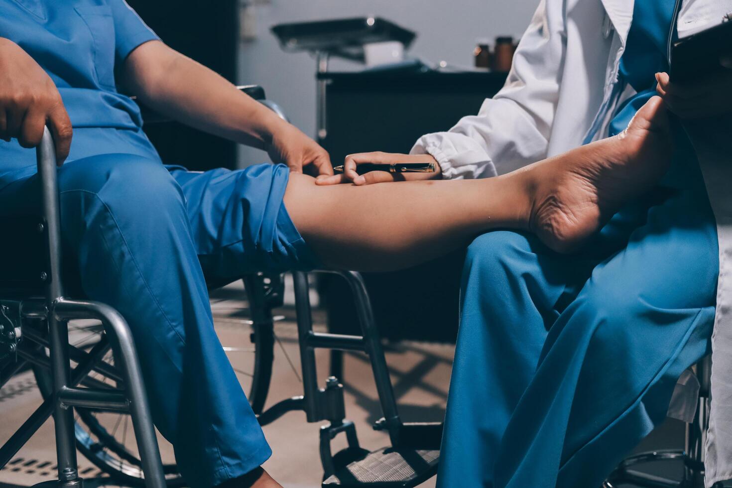 Physiotherapist nurse doing physiotherapy to rehabilitate leg of elderly female patient. photo