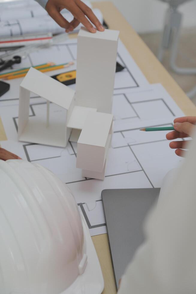 Construction and structure concept of Engineer or architect meeting for project working with partner and engineering tools on model building and blueprint in working site, contract for both companies. photo